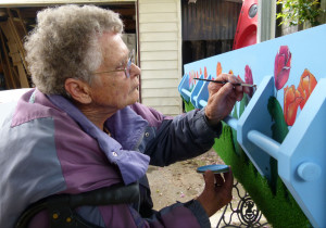 Finishing touches: Rose Gray paint tulips on her coffin to represent her Dutch heritage.