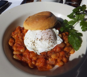 Cannellini beans in tomato sauce topped with a poached egg at Metropolis. Photo: Mackenzie Mccarty