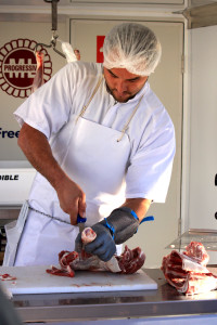 Photo: Garnett Rapana, 30, demonstrates his knife handling skills at the Te Kuiti Meats mobile butchery Photo: Adam Edwards