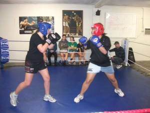 Holly Smith, left, about to throw the first punch of a training fight at Te Awamutu Boxing Club, under the watchful eye of her coach Rodd Jefferies, right