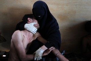 A woman holds her wounded son during protest against president Saleh, Sanaa, Yemen, 15 October.