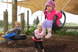 FUN ON THE SWINGS: Blake Gower (left), Olivia Fagon and Lily Cullen (right). Photo: Daniel Whitfield