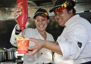 Sauce with that?Kelly Whaanga and Nicola Rivers keep Fieldays punters going. Photo: Geoff Ridder